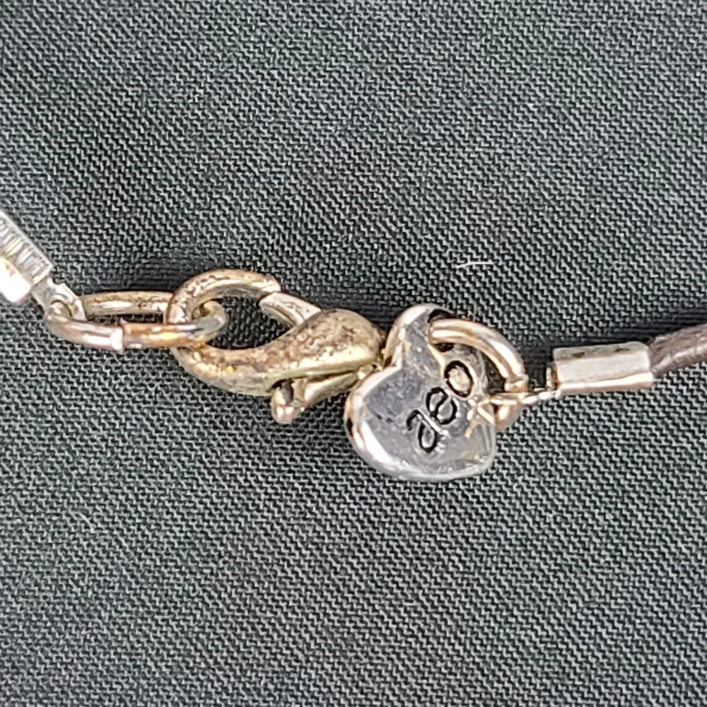 American Eagle Outfitters Necklace: leather and Mother of Pearl Disks.